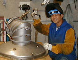 Our in-shop welder working on a water cooled pump-neck for a Model J High Vacuum Furnace